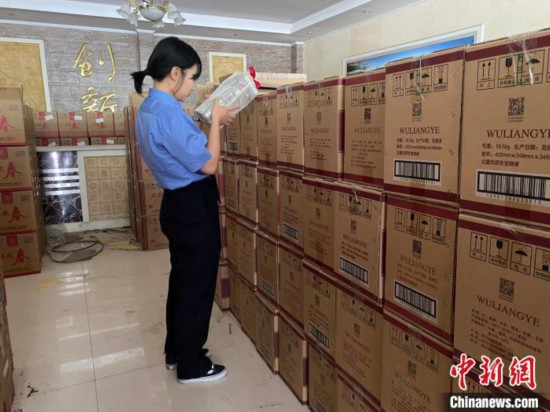 资料图为检察人员核对查获的假冒品牌白酒。青海省人民检察院供图
