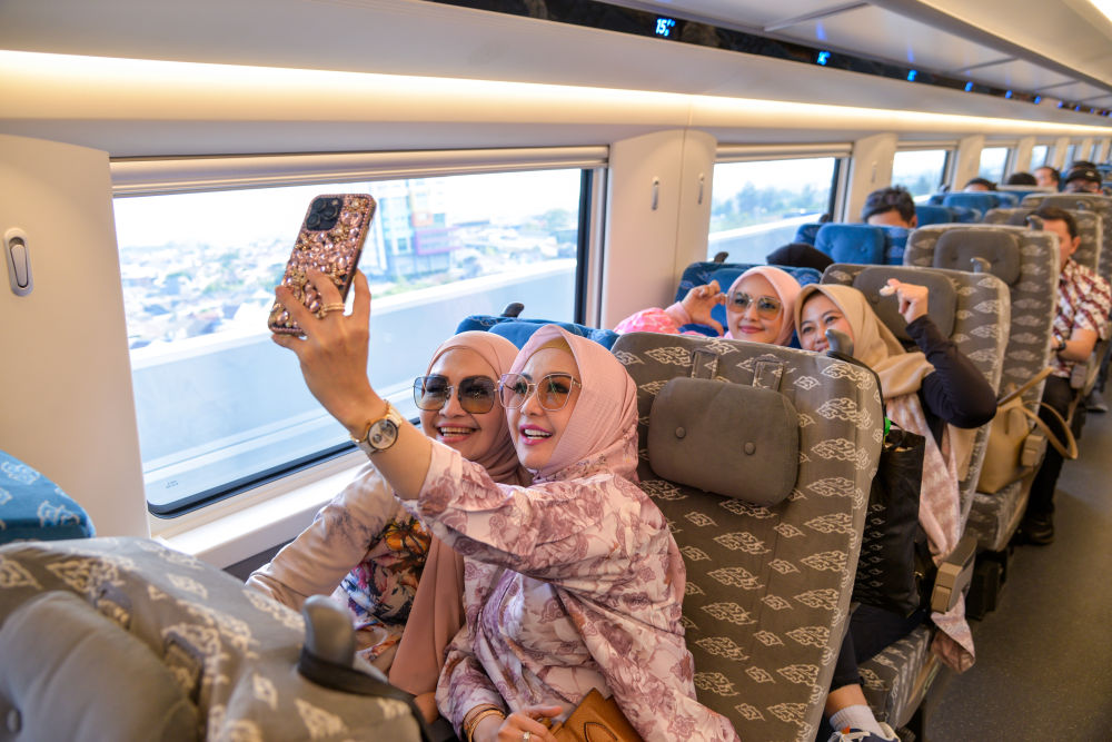 2023年10月17日，乘客在行驶中的雅万高铁高速动车组列车车厢内拍照。新华社记者 徐钦 摄