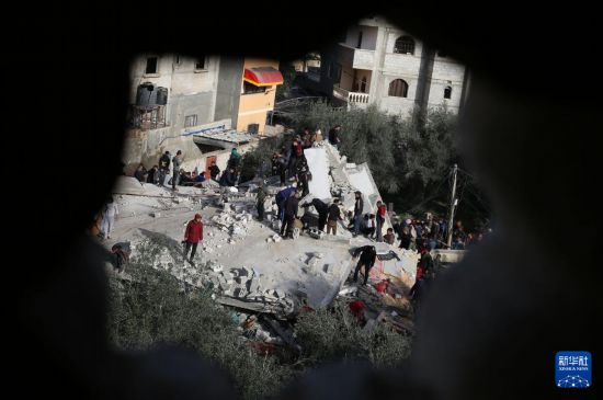  3月3日，在加沙地带南部城市拉法，人们查看被以军空袭破坏的建筑。新华社发（哈立德·奥马尔摄）