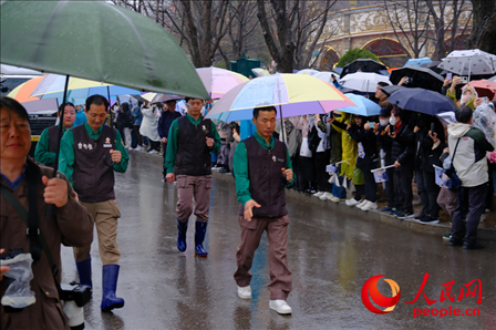 饲养员姜哲远和宋永宽为“福宝”开路送行。人民网 李帆摄