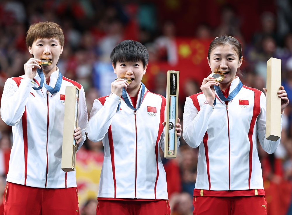 冠军中国队选手王曼昱、孙颖莎、陈梦（从左至右）在巴黎奥运会乒乓球女子团体颁奖仪式上（2024年8月10日摄）。新华社记者 王东震 摄