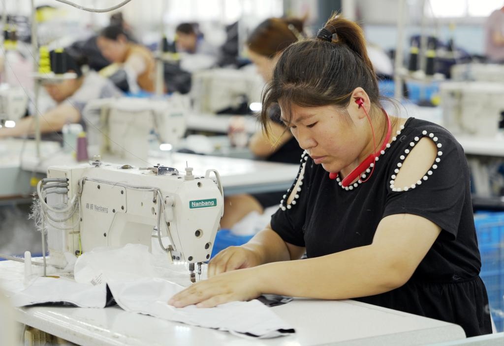 5月20日，村民在李寨村服装加工厂内忙碌。河南省周口市沈丘县冯营镇李寨村地处豫东平原。近年来，乘着脱贫攻坚与乡村振兴政策的东风，李寨村积极探索产业发展模式，通过“龙头企业+村集体经济+农户”的方式，逐渐发展形成肉牛养殖、设施农业、服装加工、康养民宿等产业，以产业振兴助力乡村振兴。新华社记者 李嘉南 摄